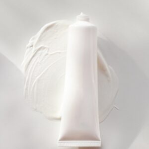 a tube of cream sitting on top of a white plate