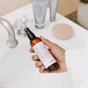 person holding white labeled bottle