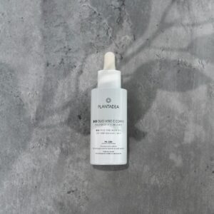 a bottle of foam sitting on top of a cement floor